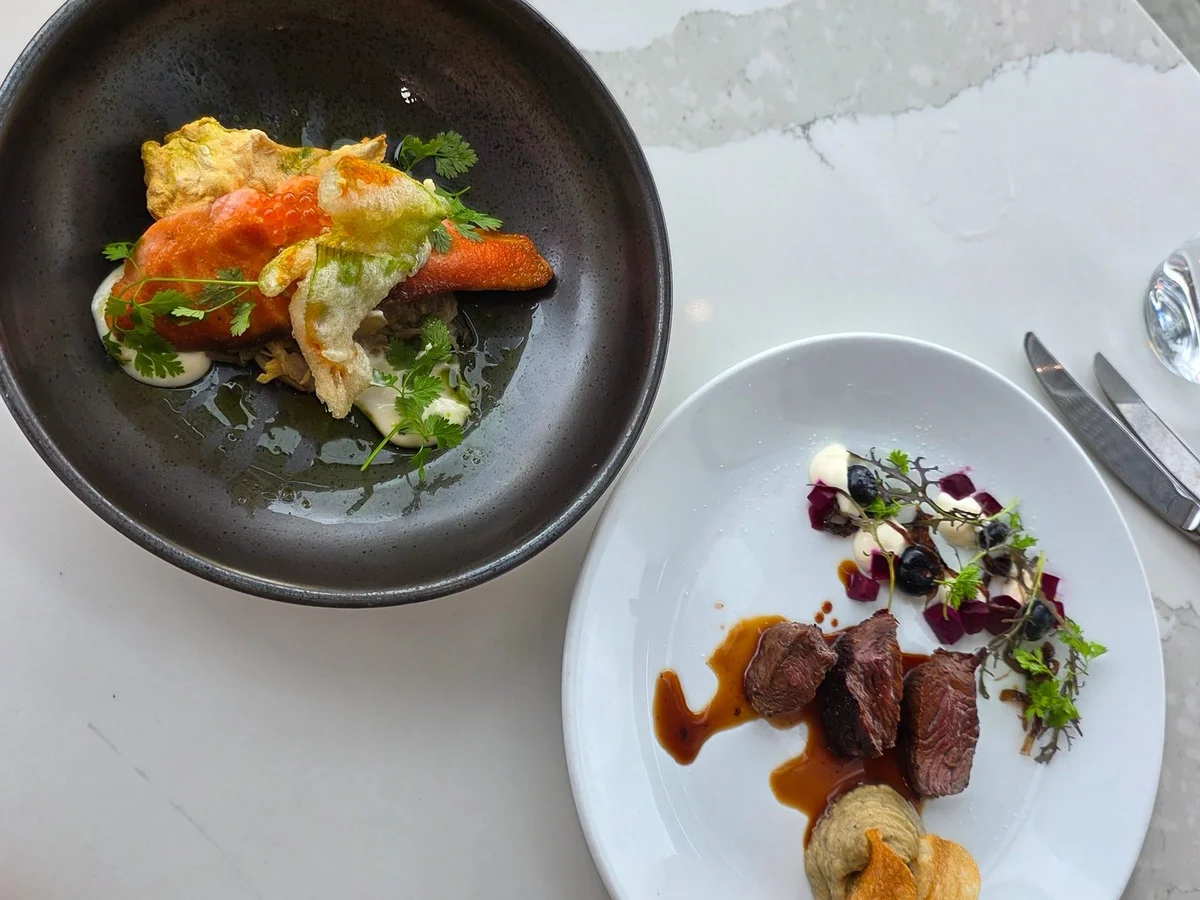 Two seasonal dishes photographed from above on a marble table